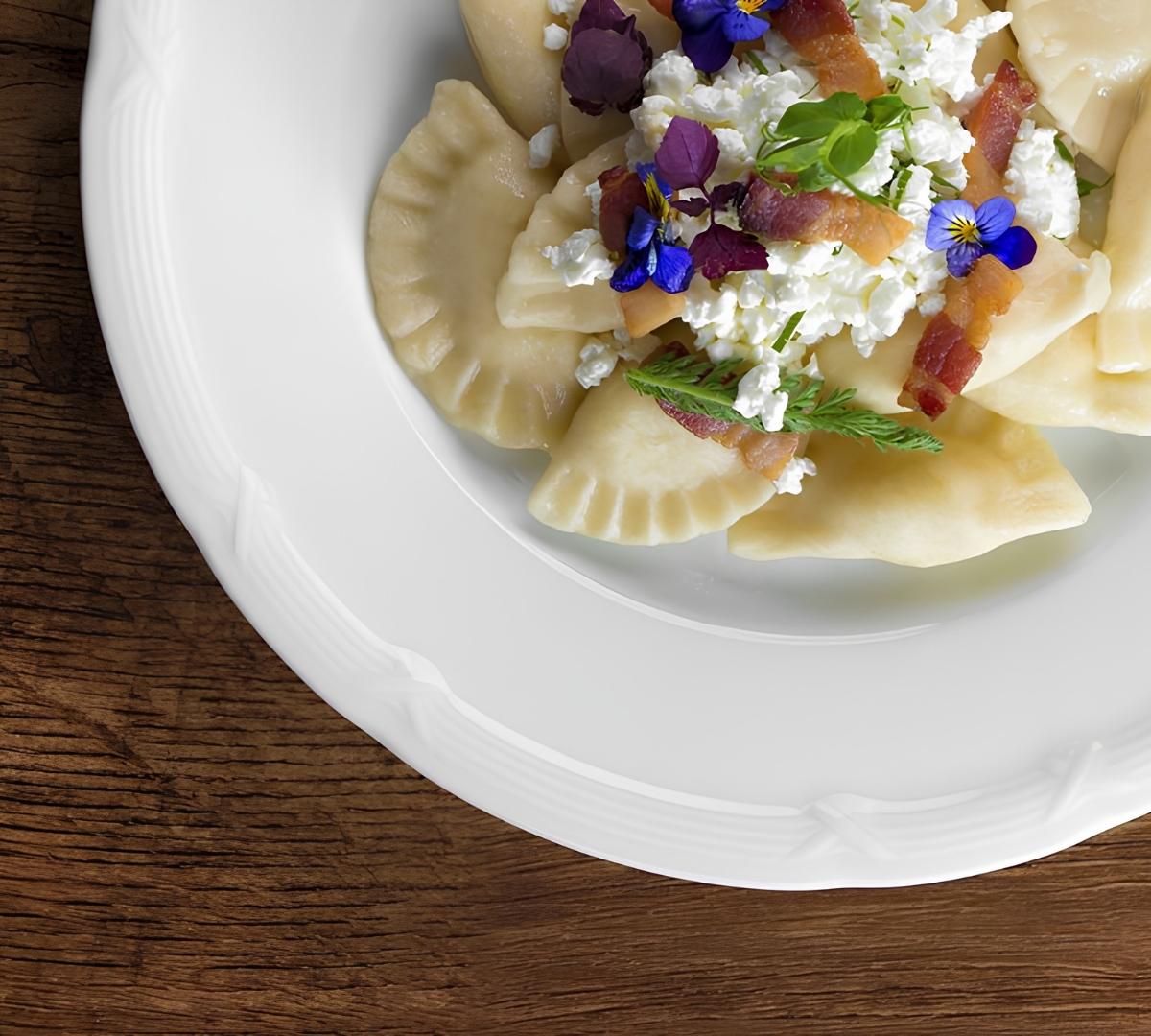 a plate of food with flowers and cheese