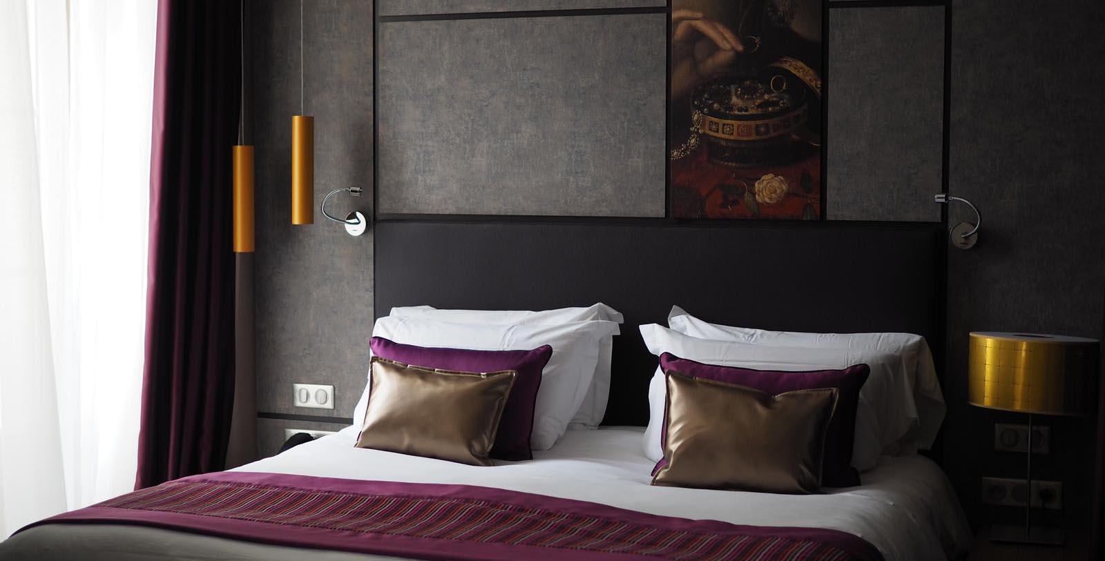 a bed with pillows and a lamp