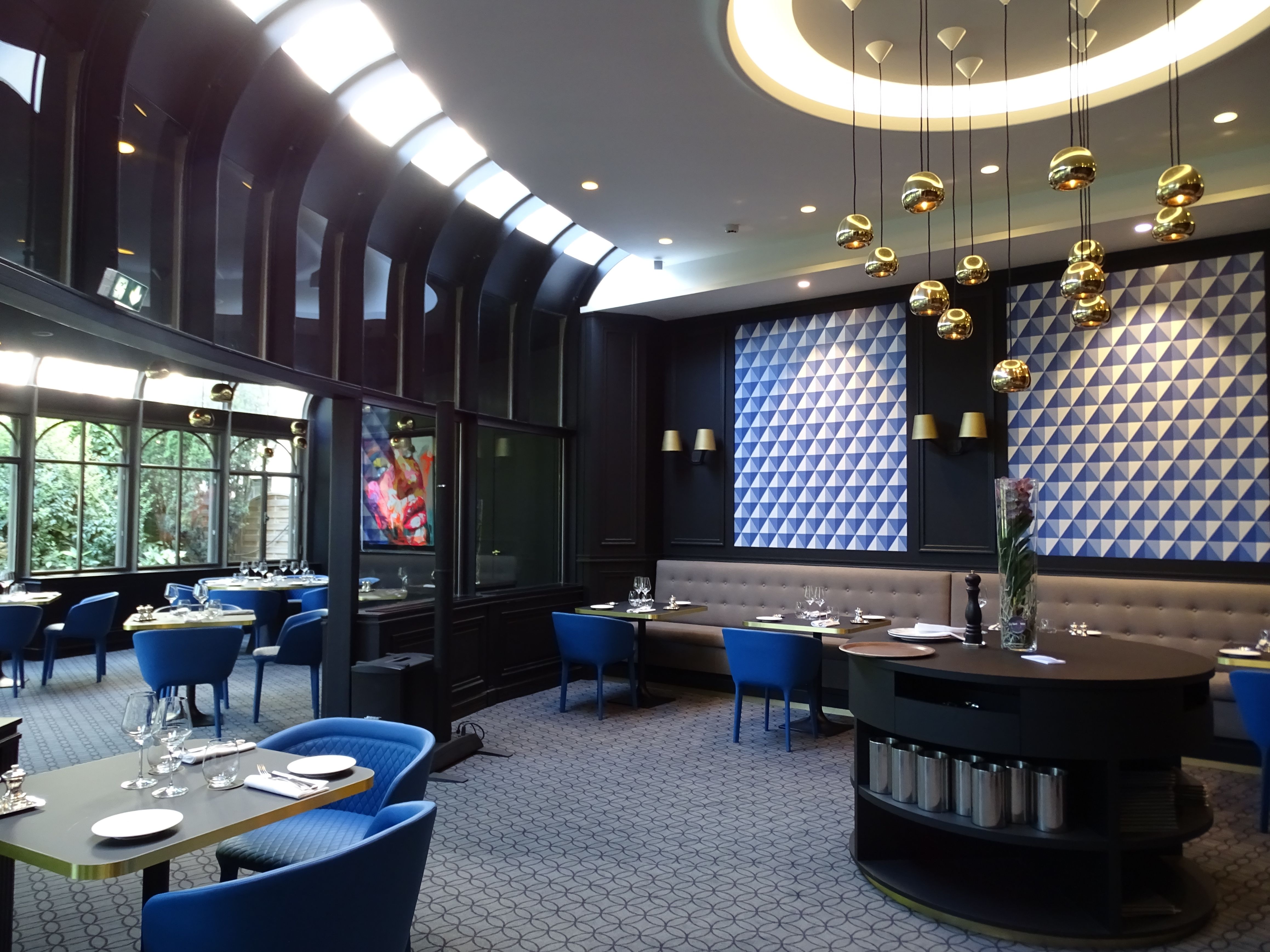 a restaurant with blue chairs and tables