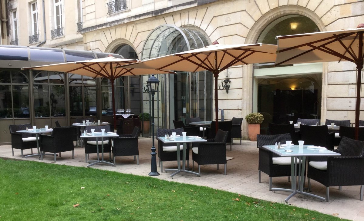 a patio with tables and umbrellas