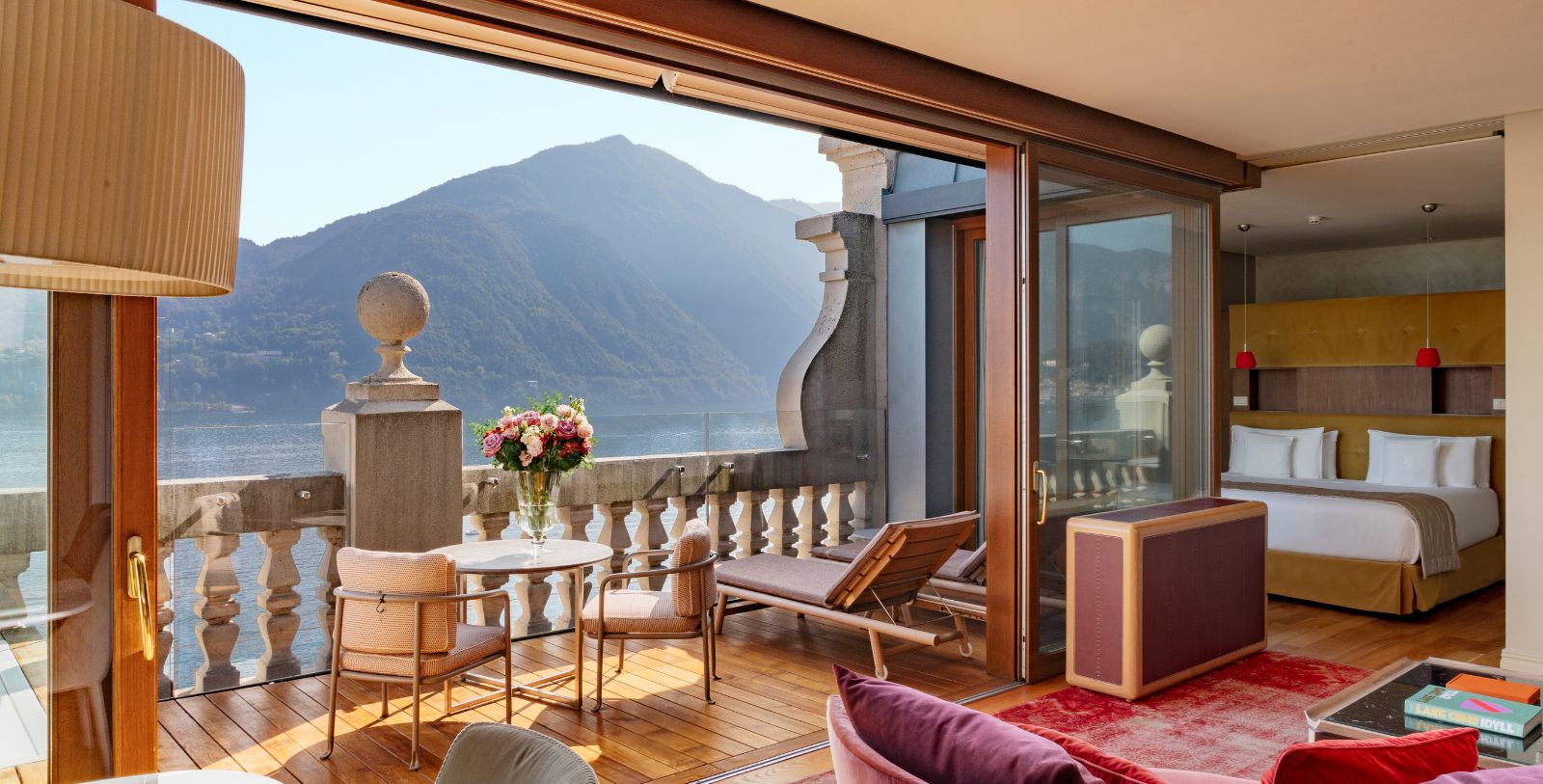 a balcony with a view of the mountains and a lake