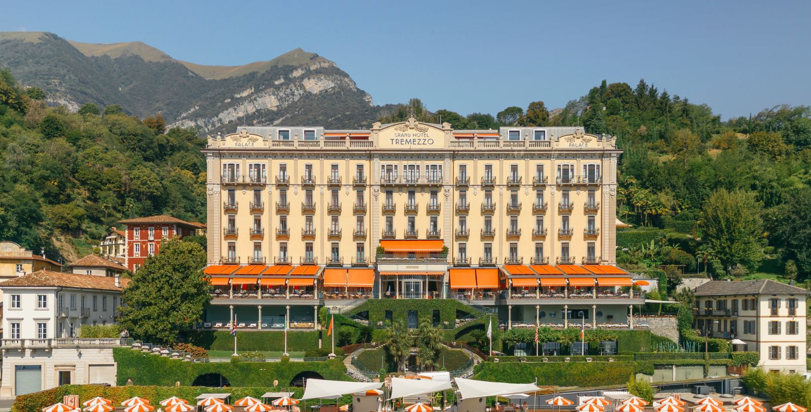 a building with many windows and orange awnings