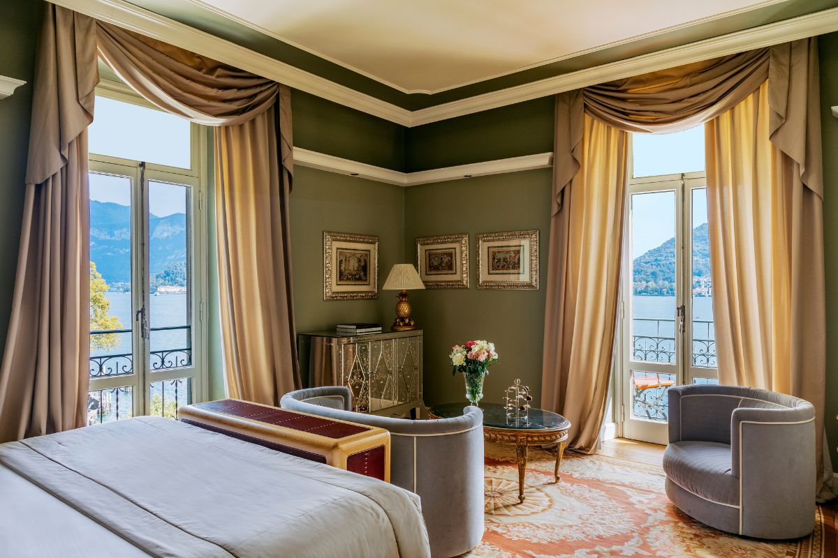 a room with a bed and a chair and a table