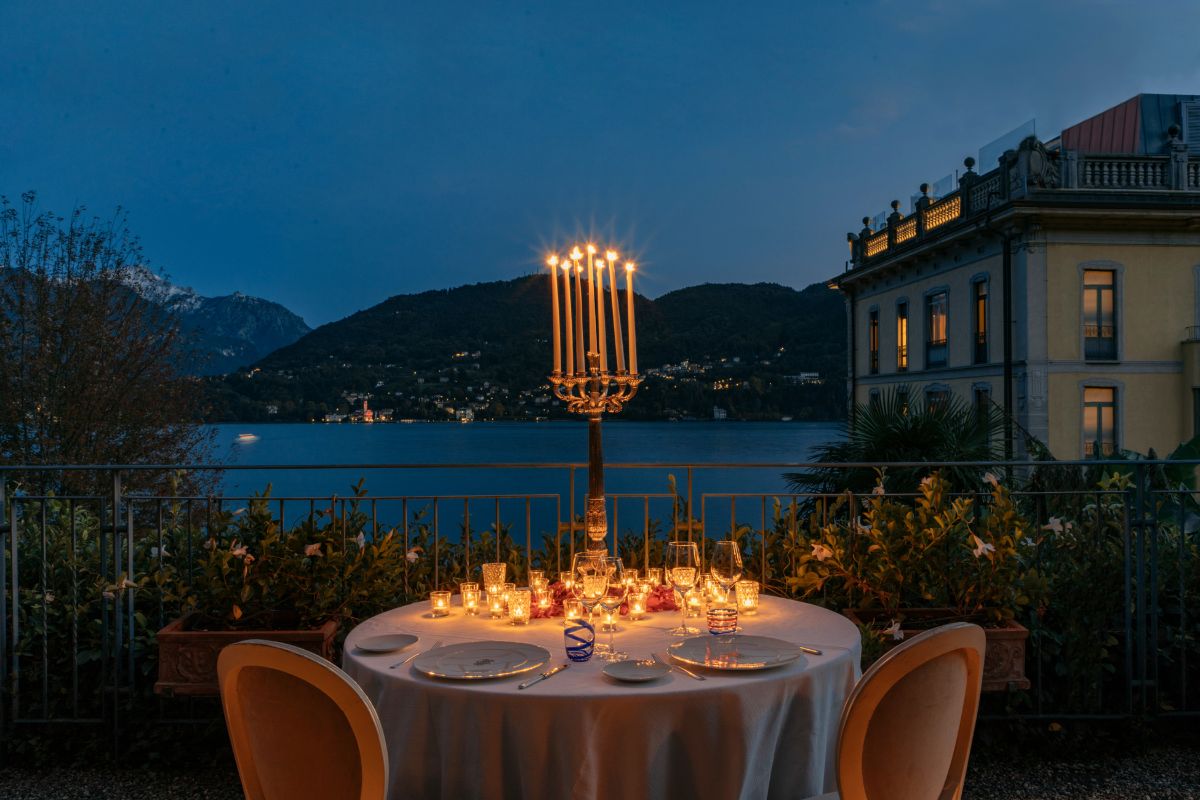 a table with candles on it and a building in the background