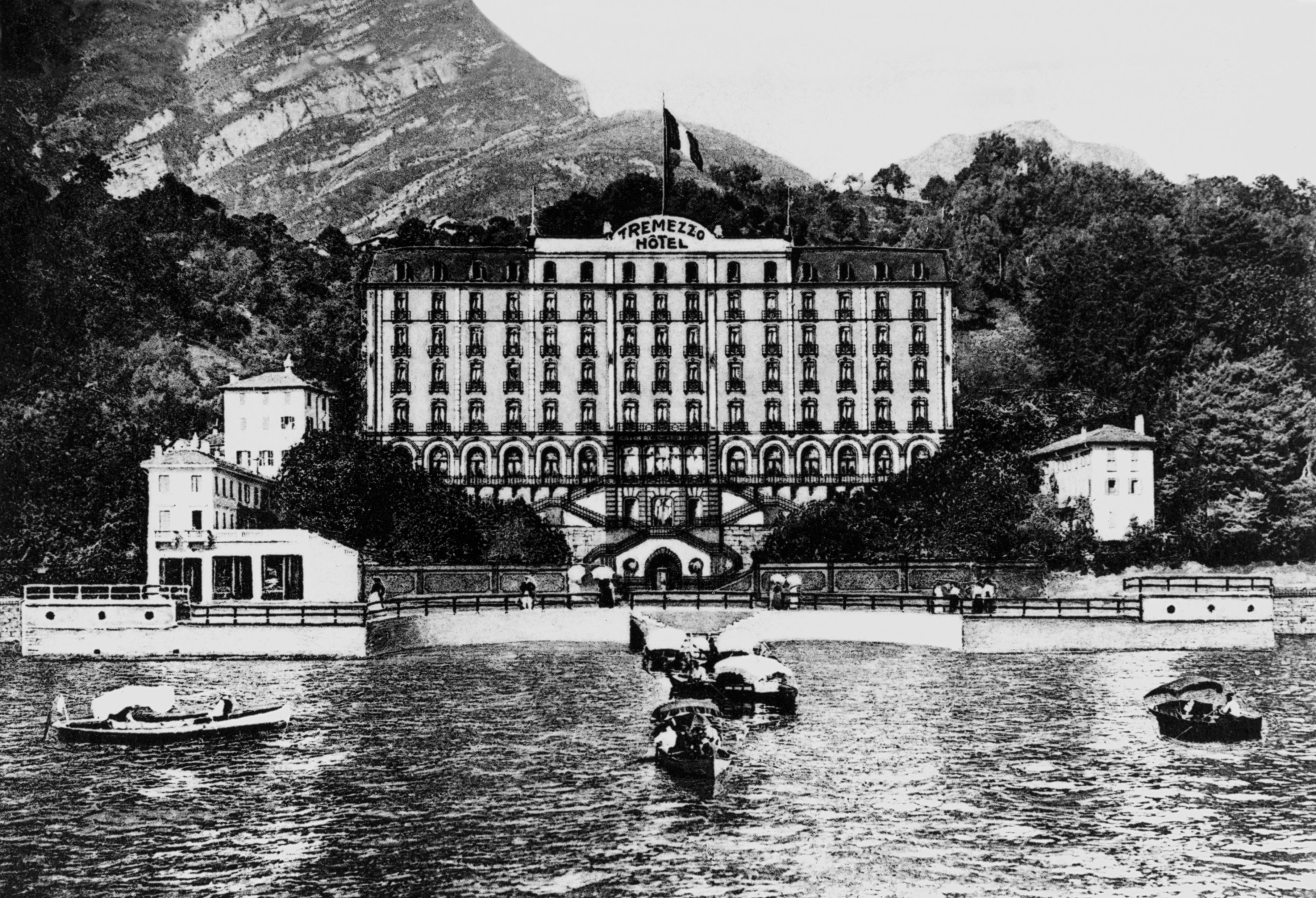 a building with many windows and a bridge over water