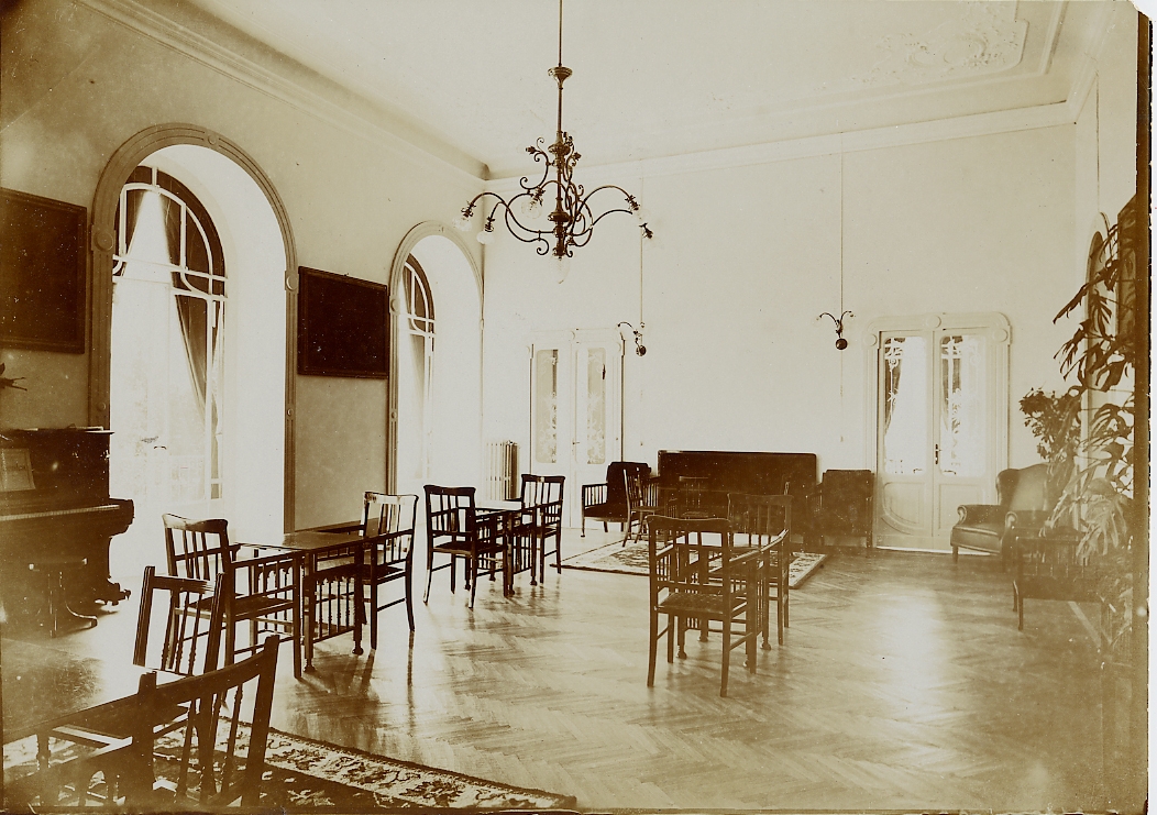 a room with chairs and a chandelier