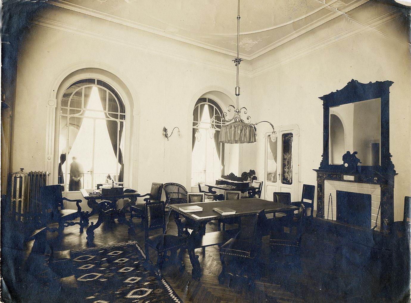 a room with a fireplace and tables