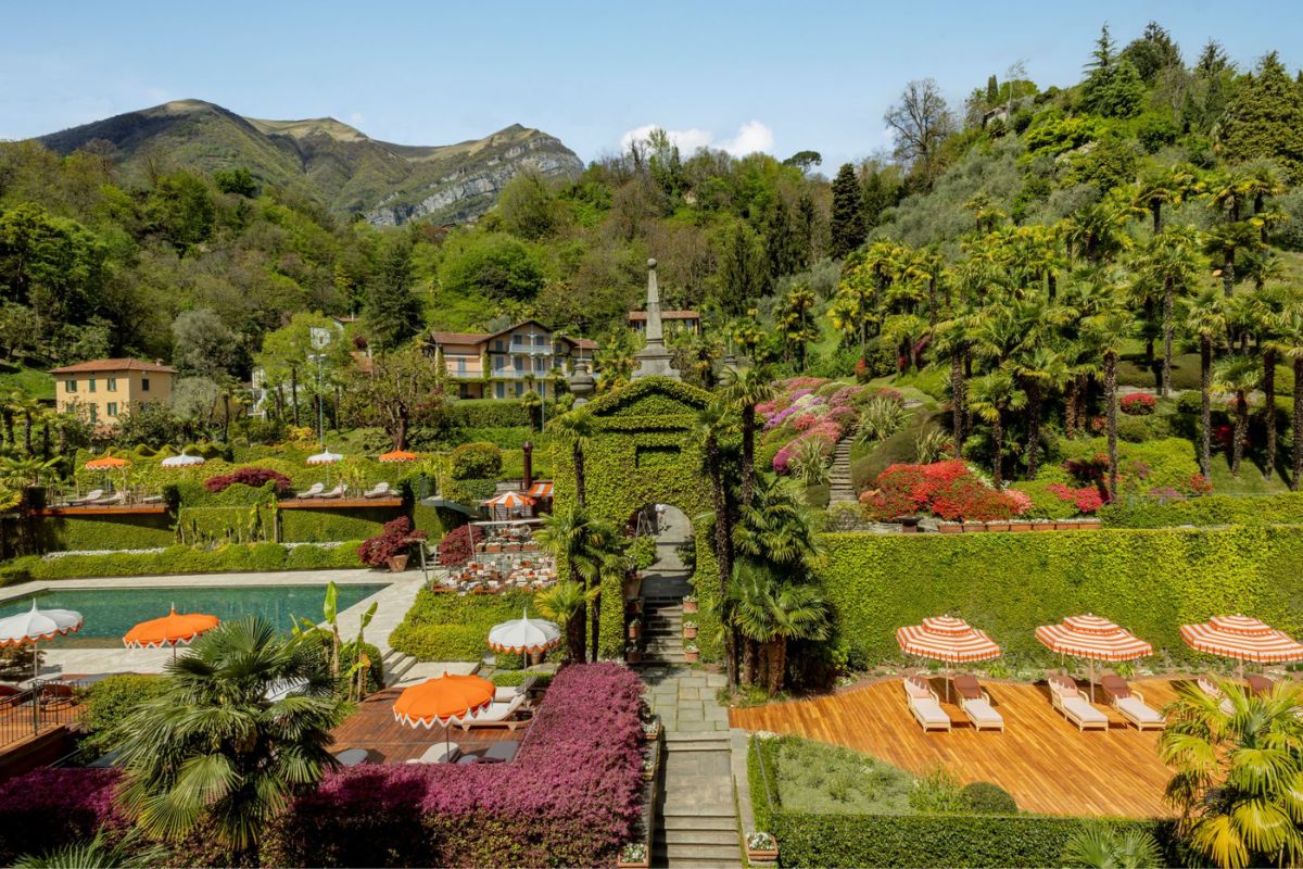 a pool in a garden with Butchart Gardens in the background