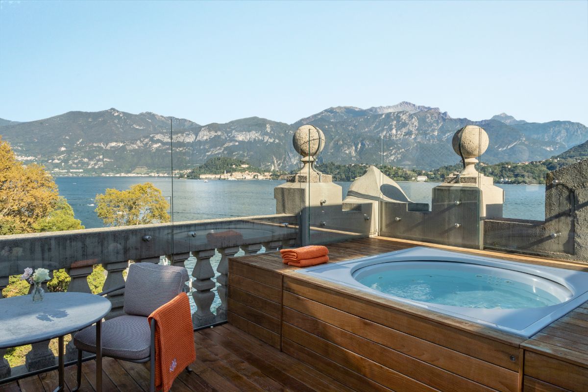 a hot tub on a deck overlooking a body of water