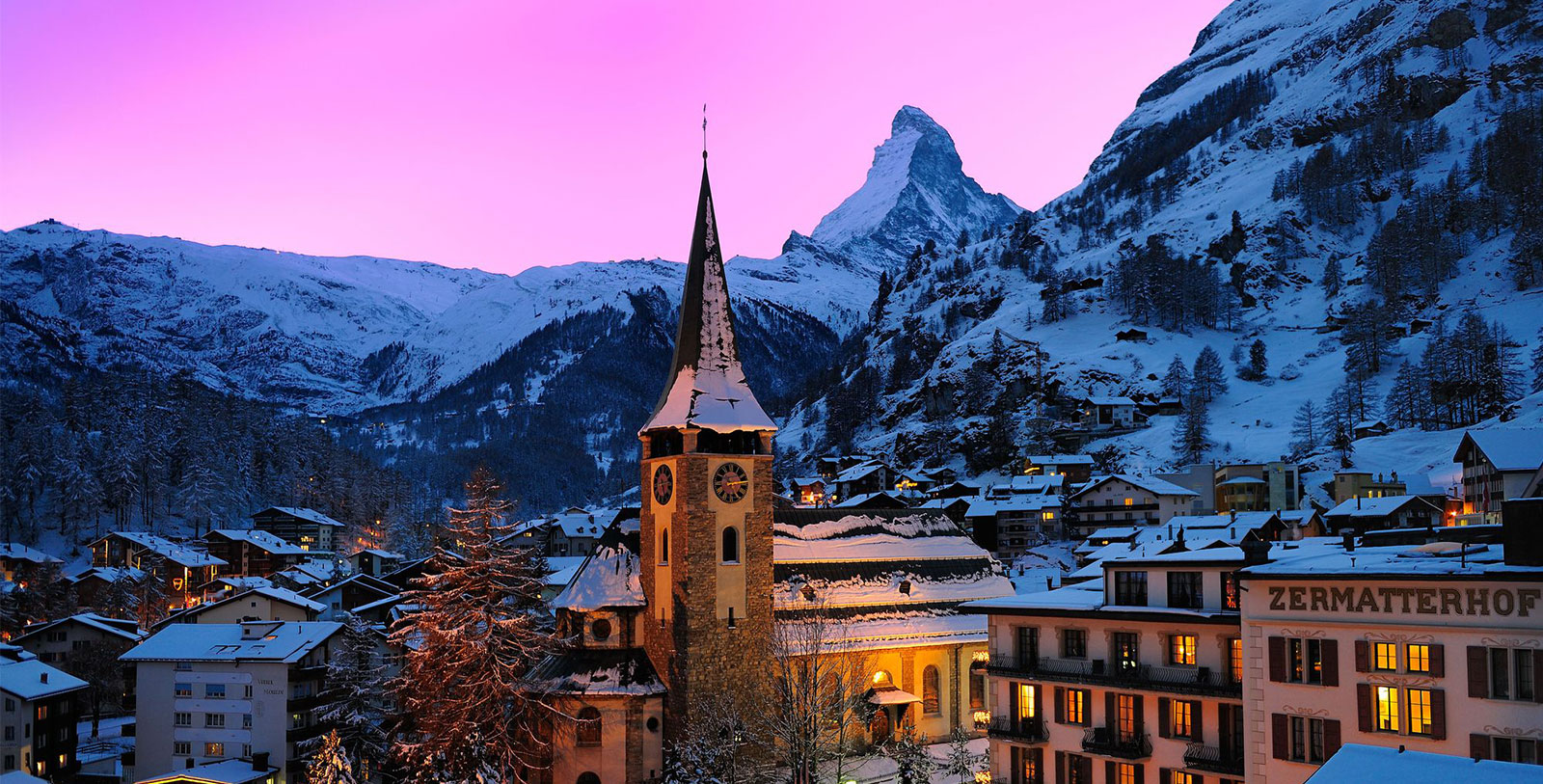 a building with a clock tower in the snow