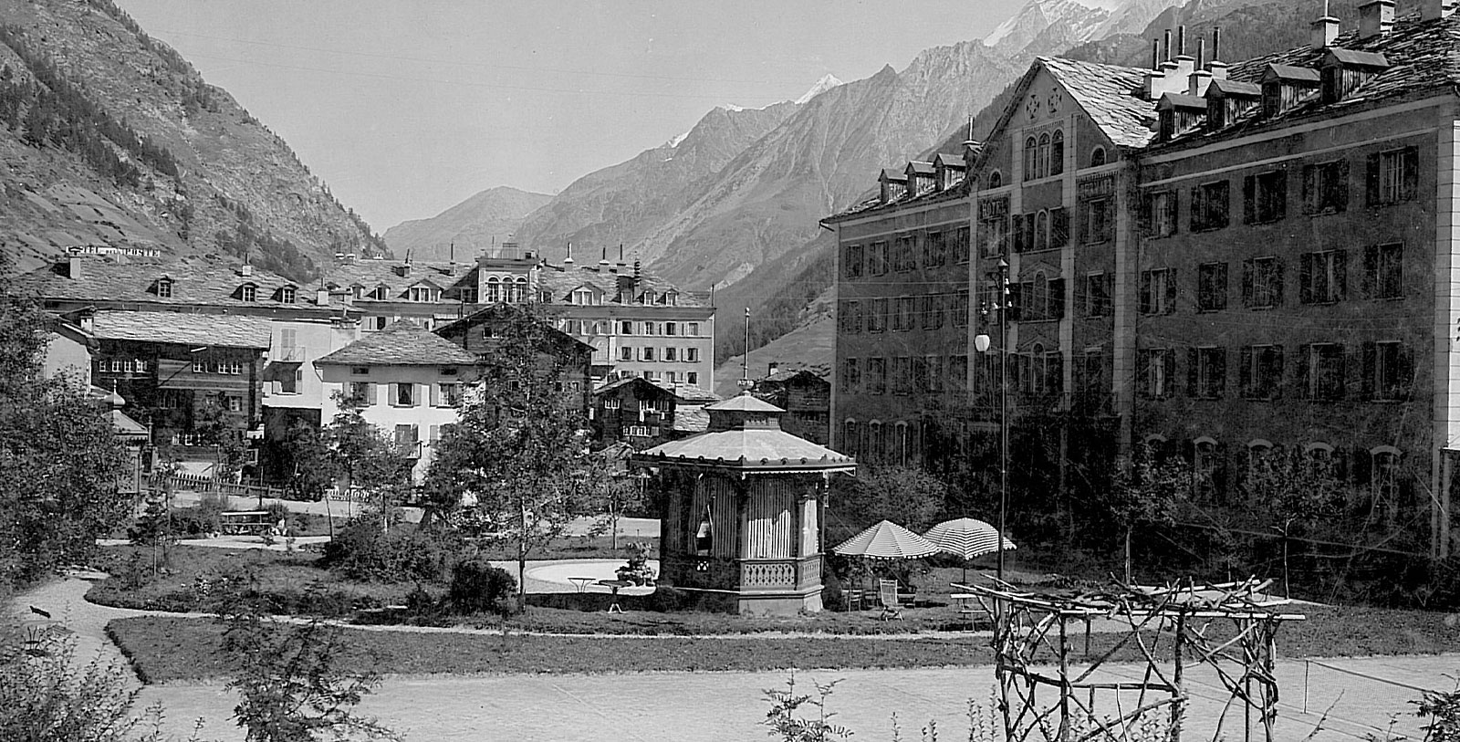 a building with a gazebo in front of a mountain