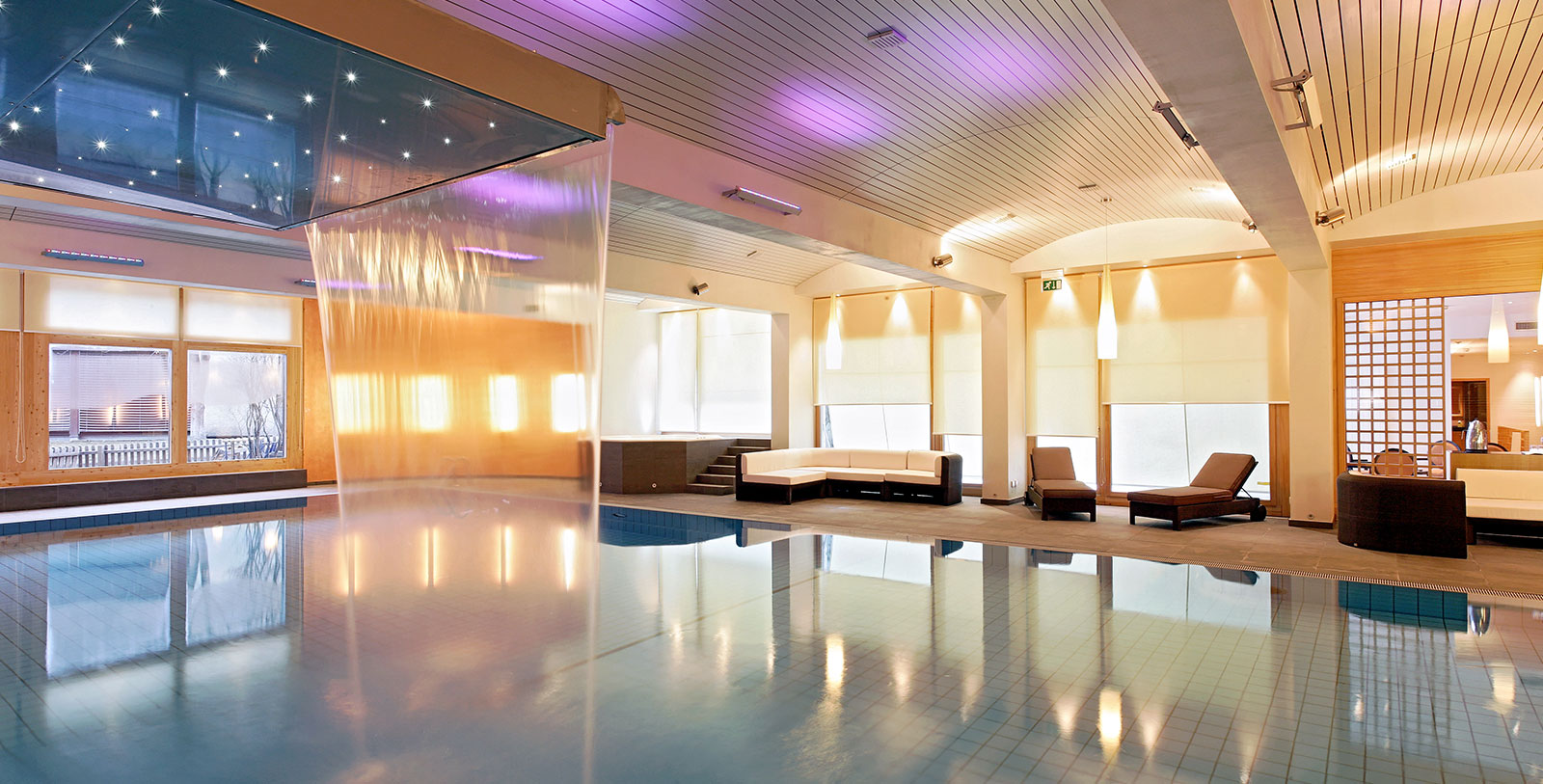 a indoor pool with a waterfall