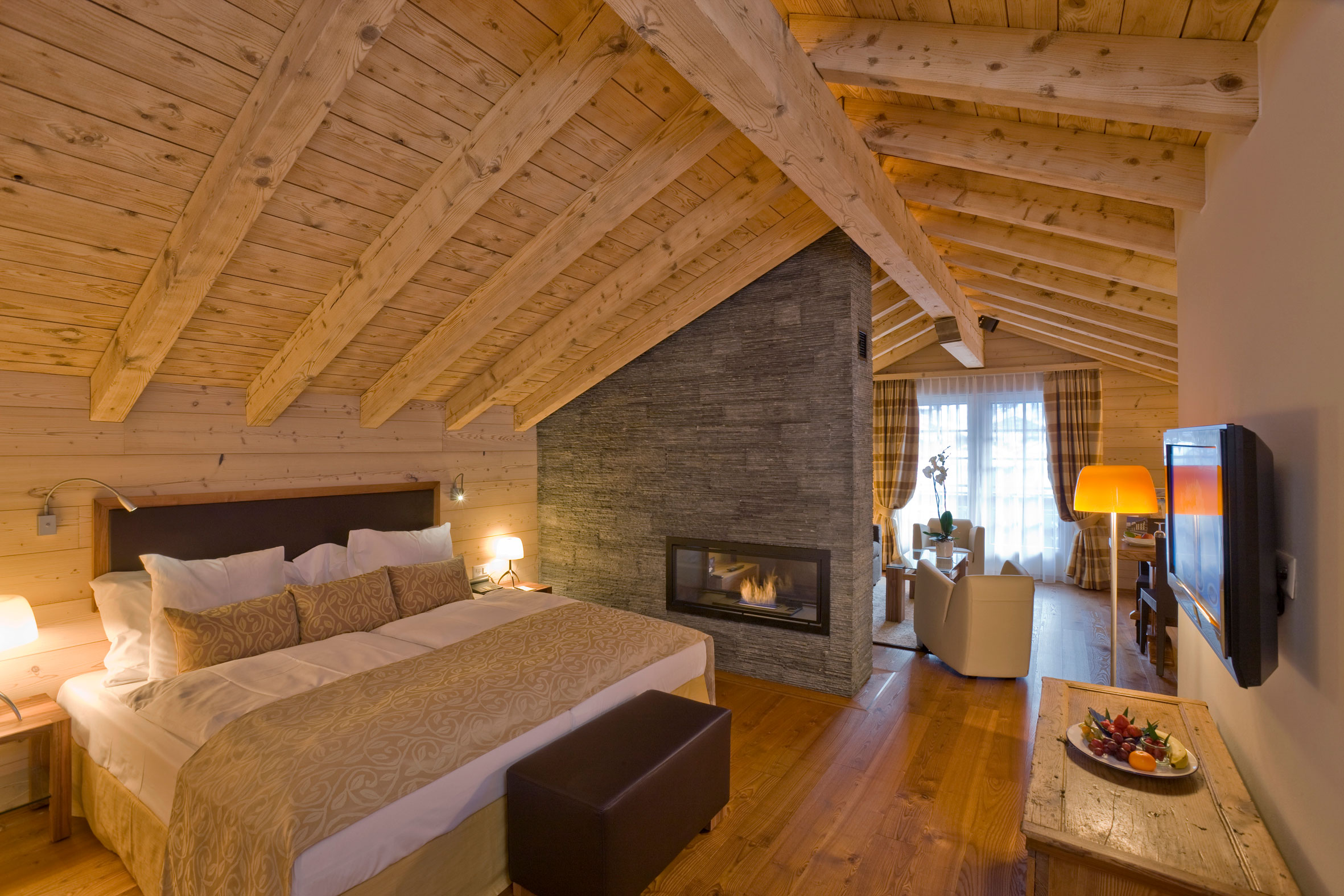 a bedroom with a fireplace and a bed