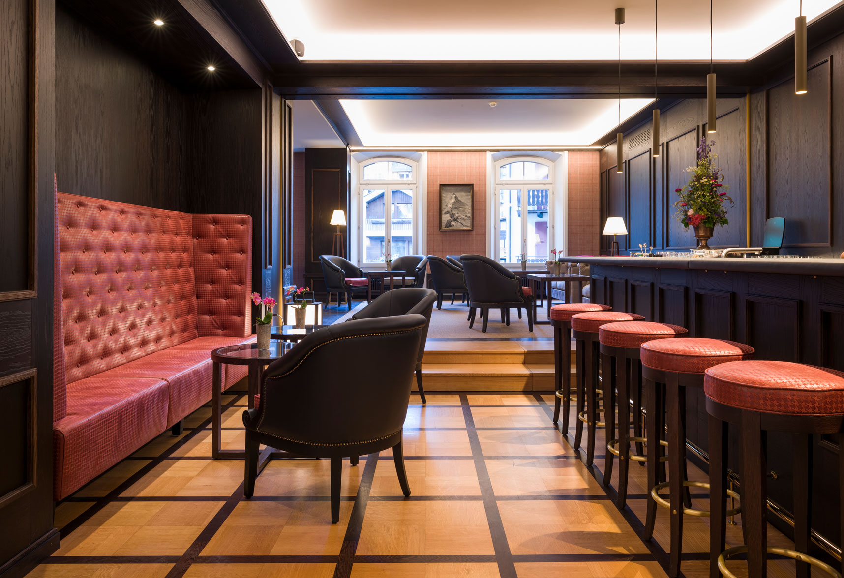 a room with a bar and chairs