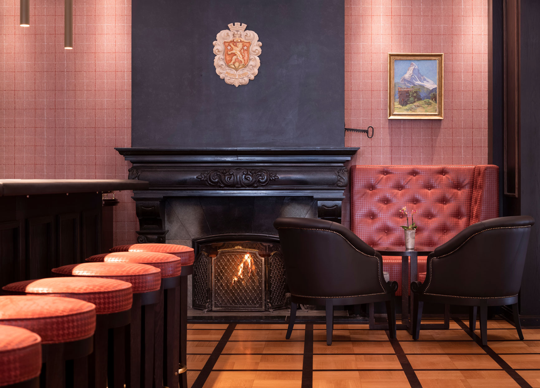 a room with red chairs and fireplace