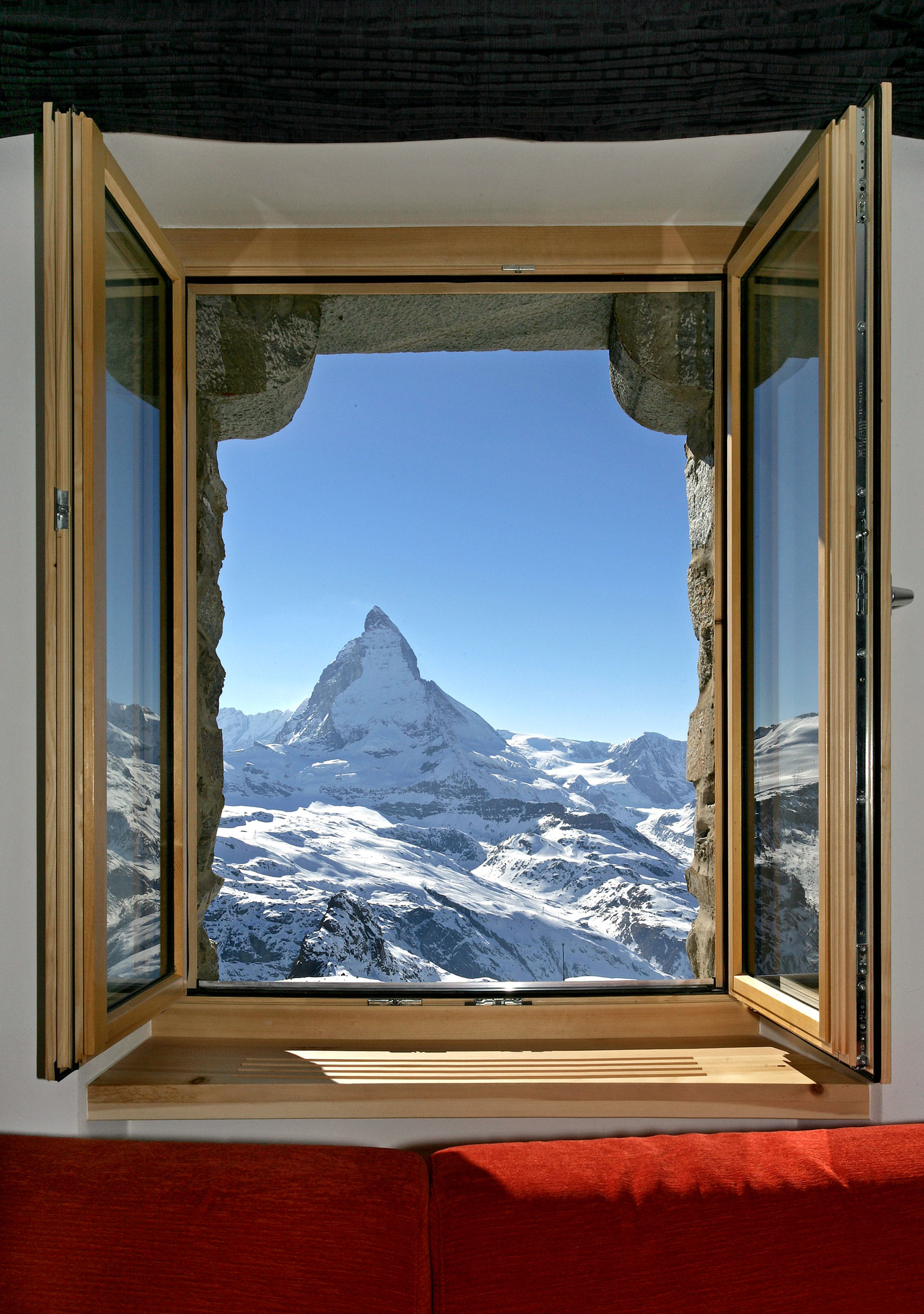 a window with a mountain range in the background