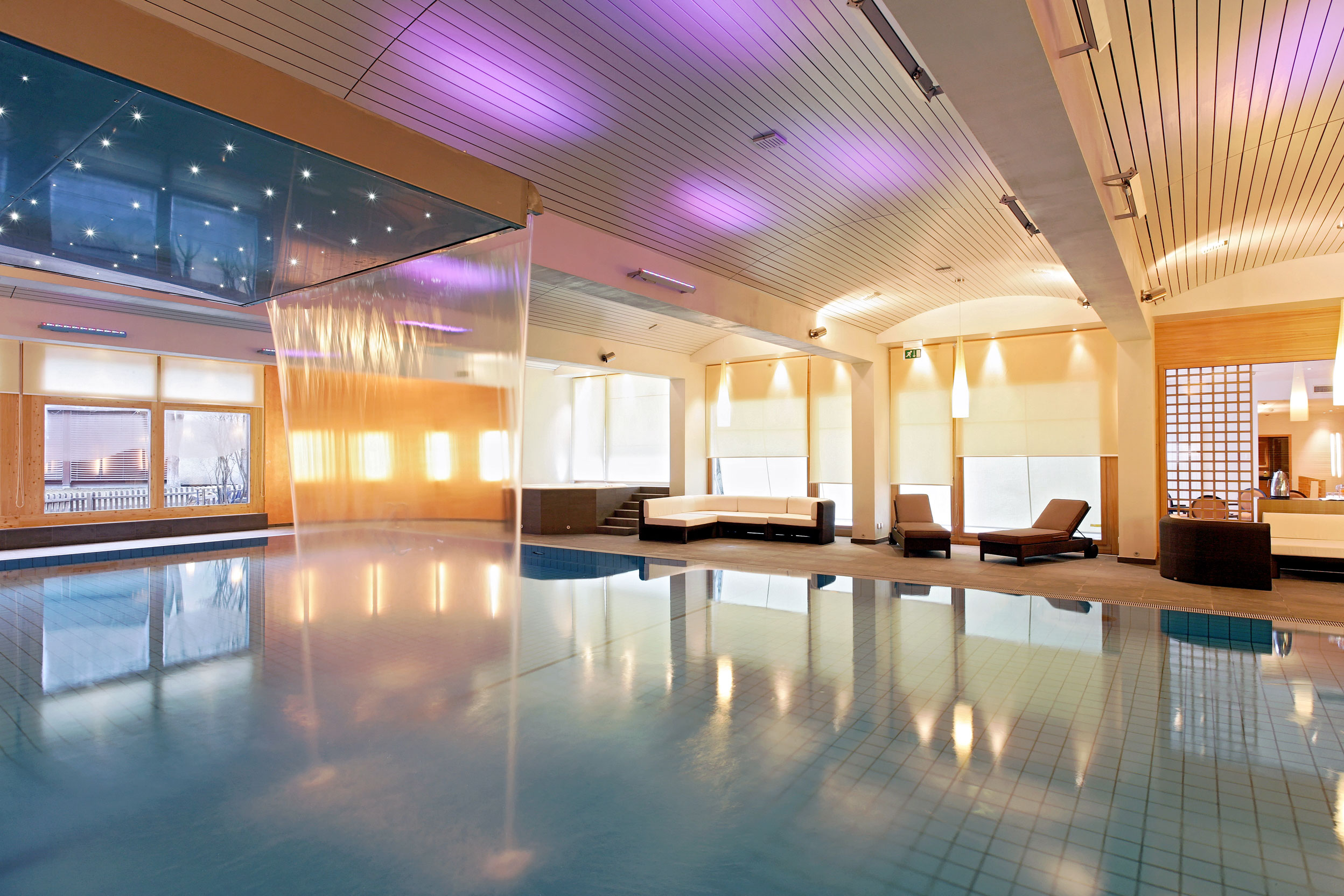 a indoor pool with a waterfall