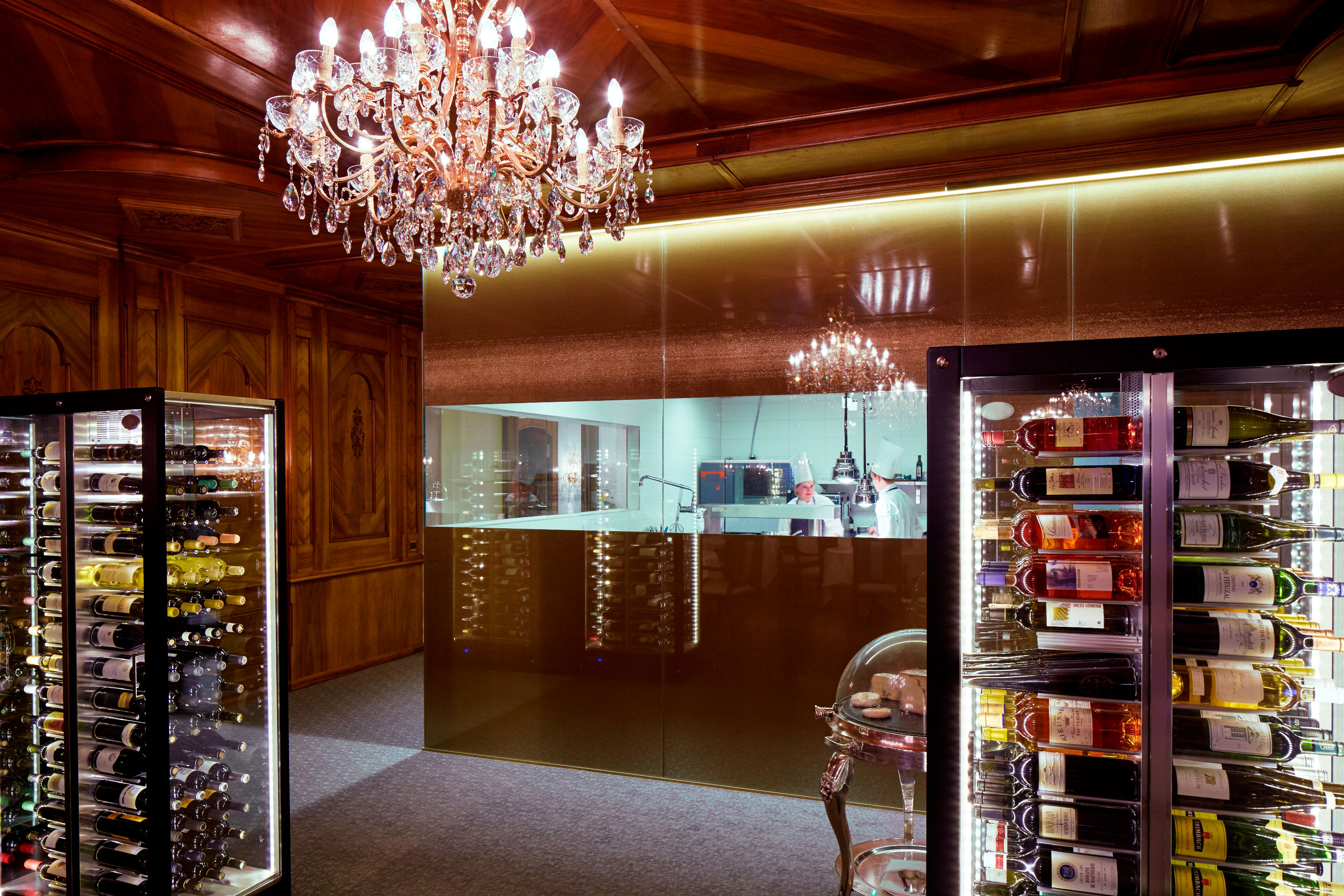 a room with a chandelier and a glass door