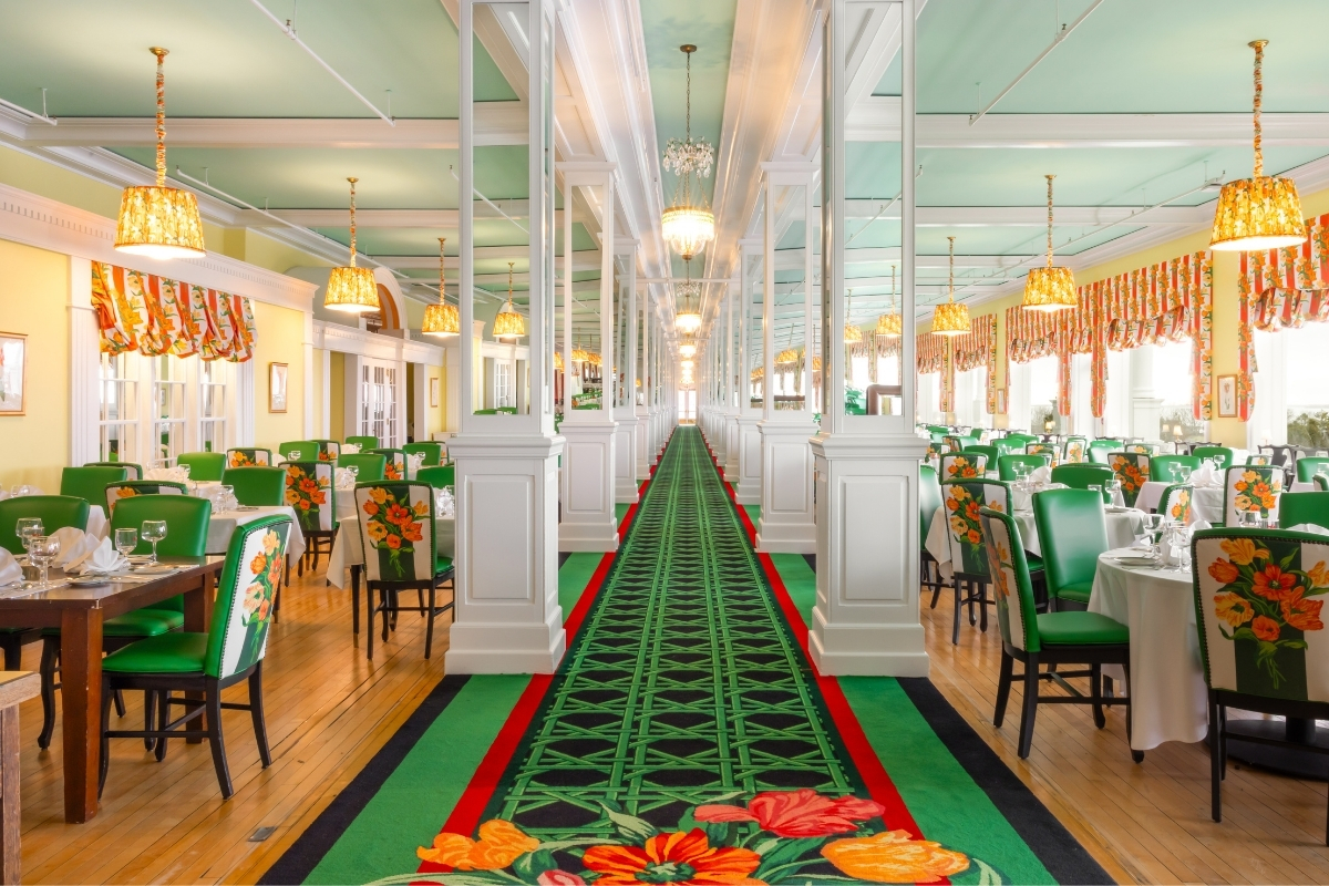 a long hallway with tables and chairs