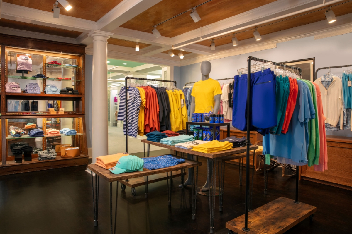 a store with a mannequin in a yellow shirt and blue pants