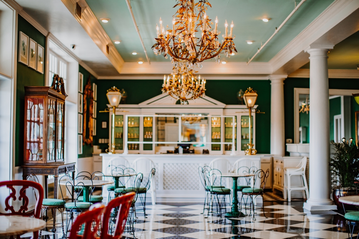 a room with tables and chairs and a chandelier