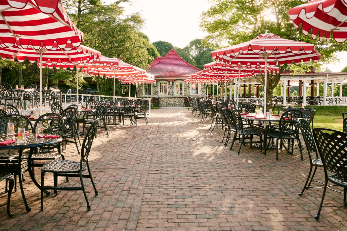 a patio area with tables and umbrellas