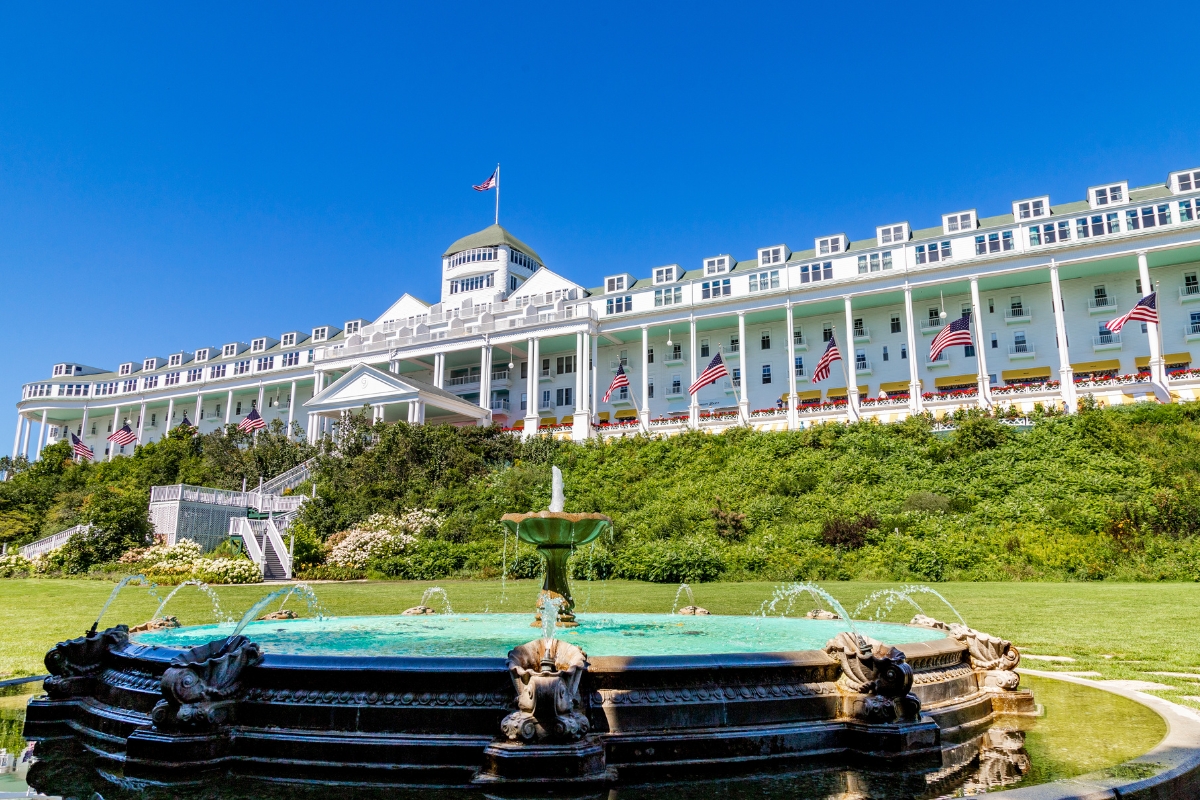a fountain in front of a large white building