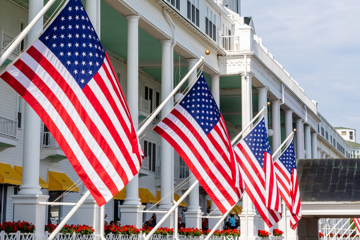 a row of american flags outside of a building