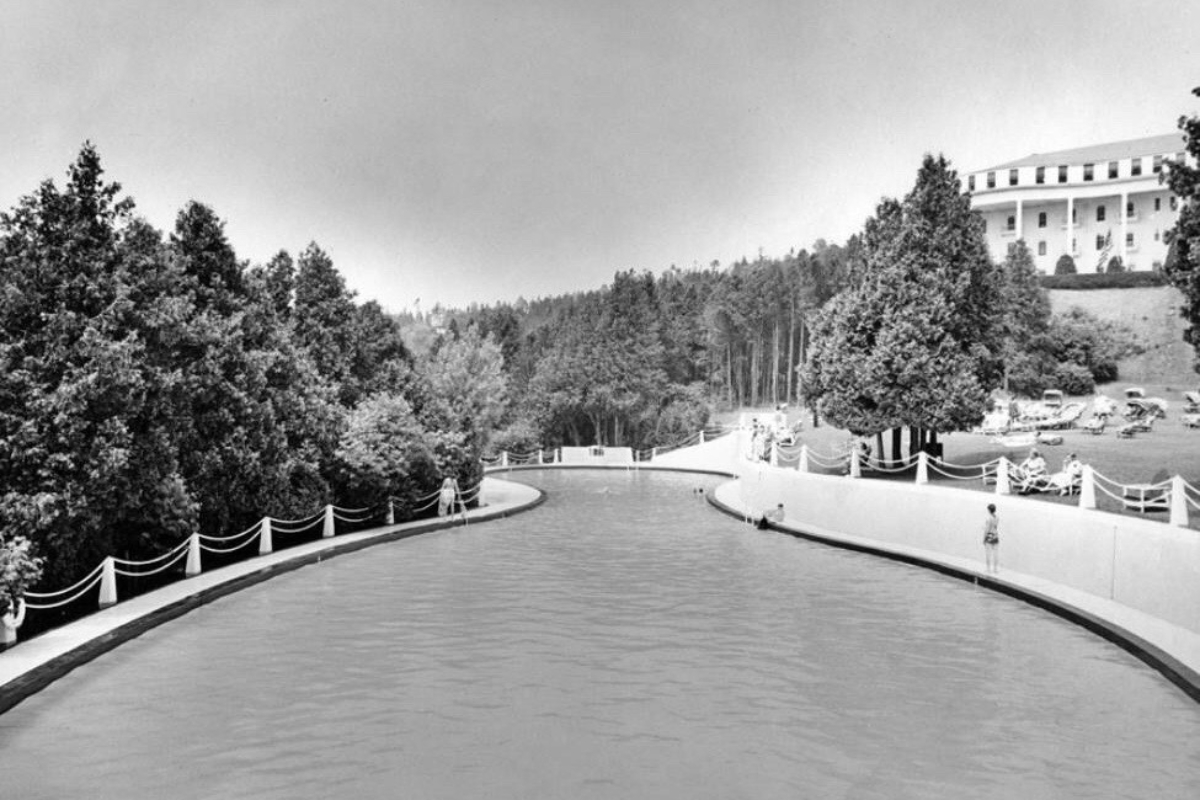 a canal with trees and a building