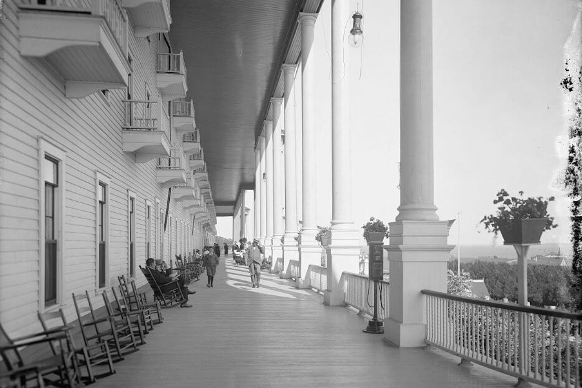 a long walkway with chairs and people on it