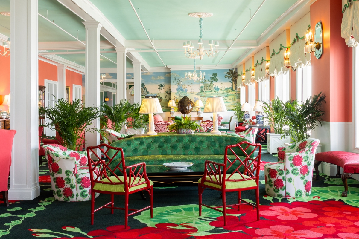 a room with a green couch and chairs
