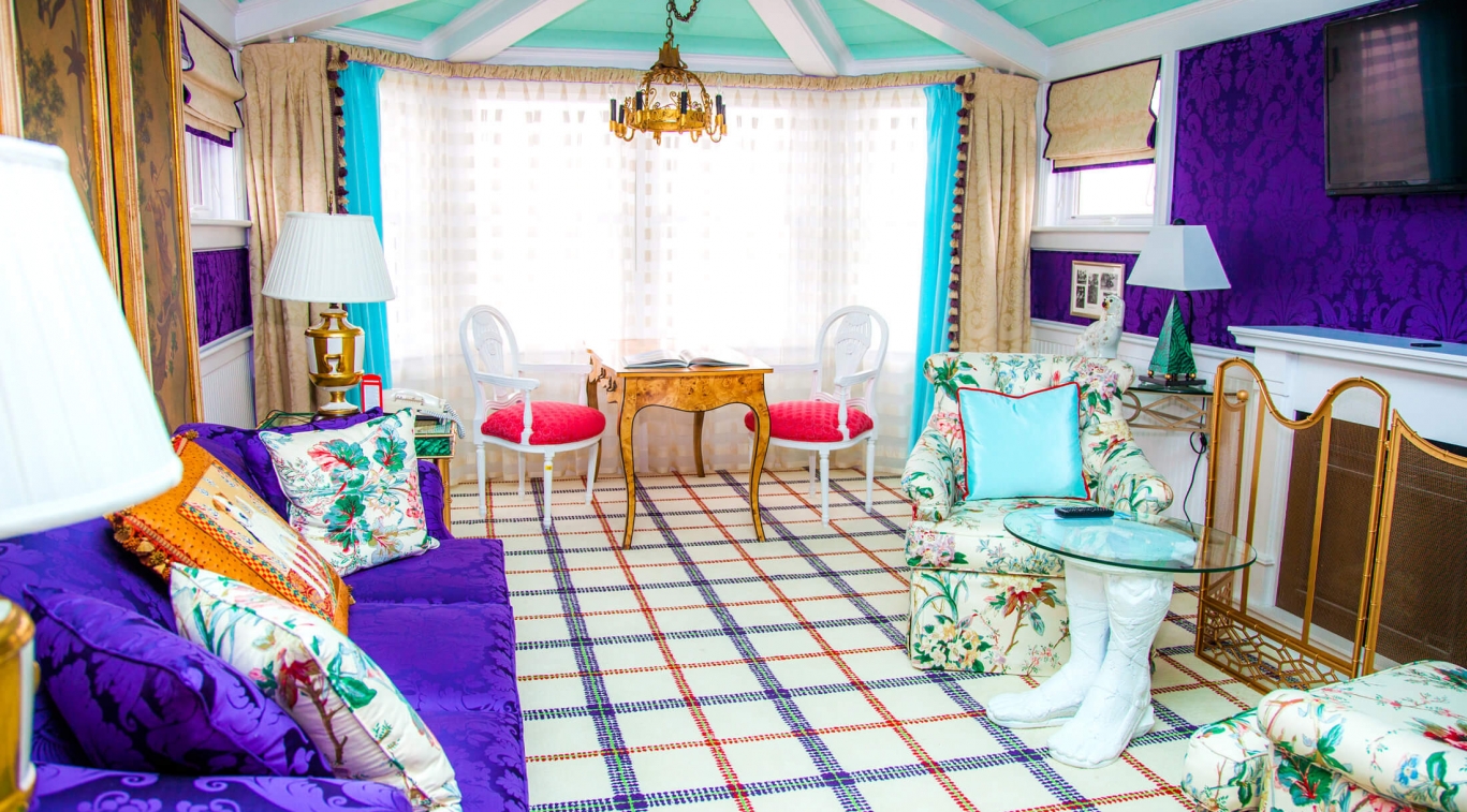 a room with colorful furniture and a table