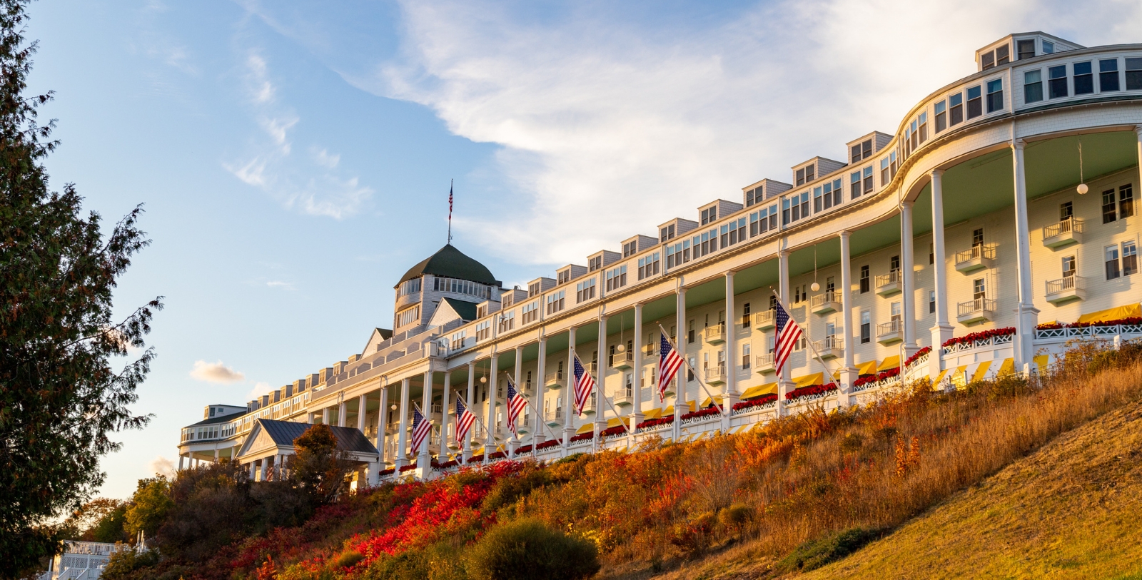 a large white building with flags on the side