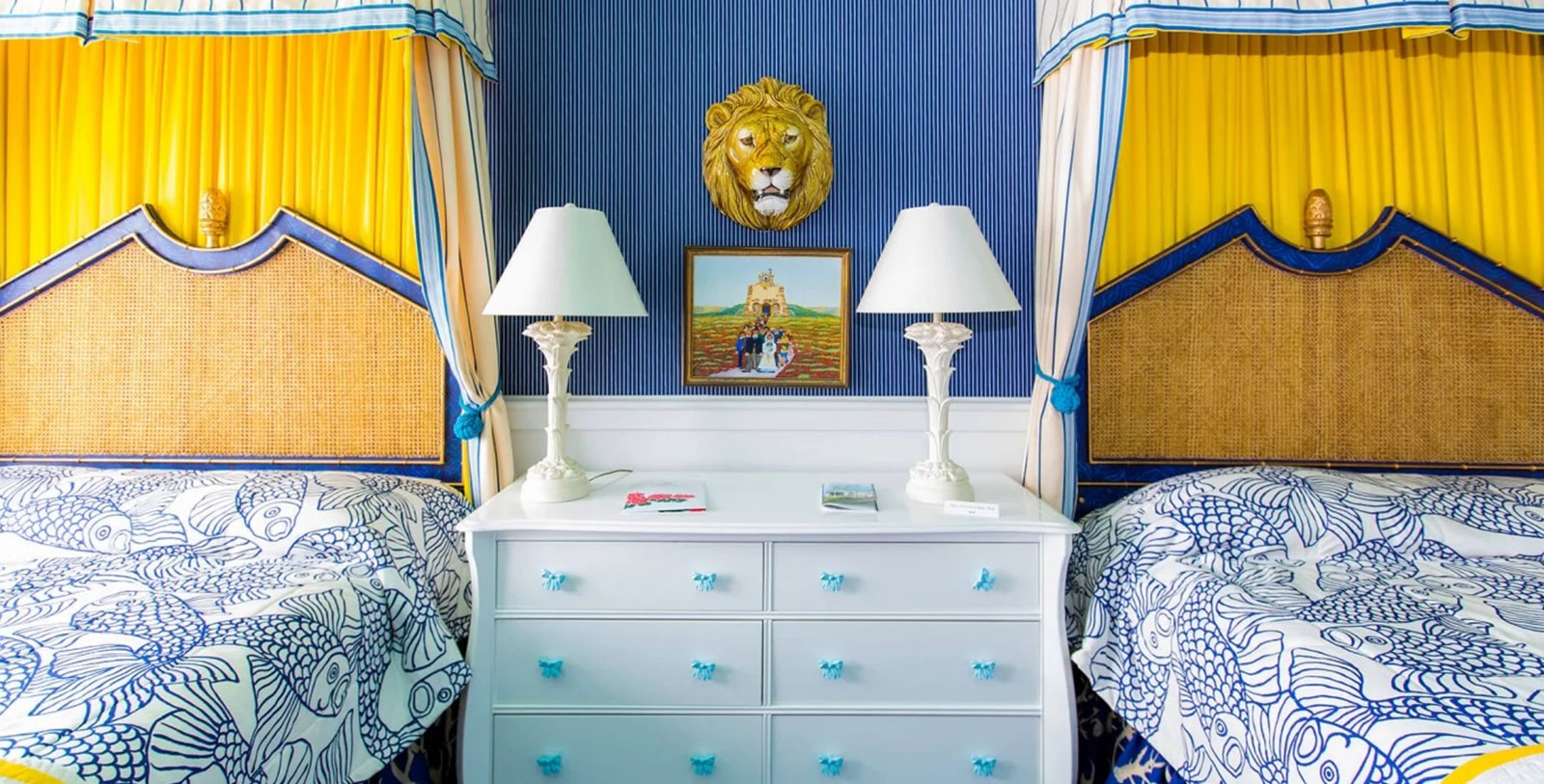 a white dresser with lamps and a picture of a lion on the wall