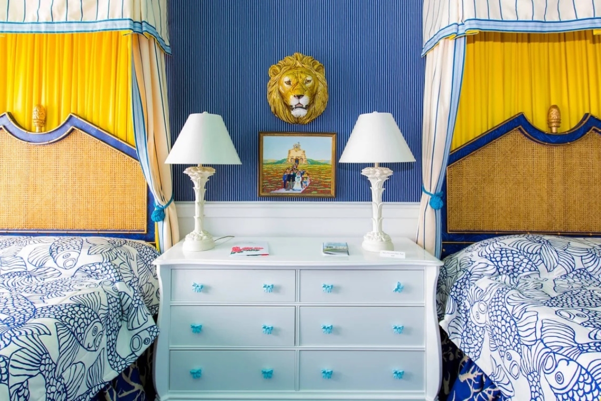 a white dresser with lamps and a picture of a lion on the wall