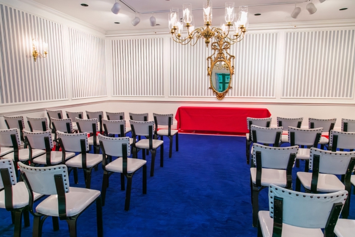 a room with chairs and a chandelier