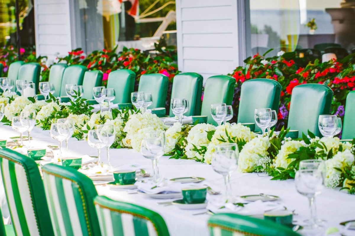 a table set with flowers and glasses on it