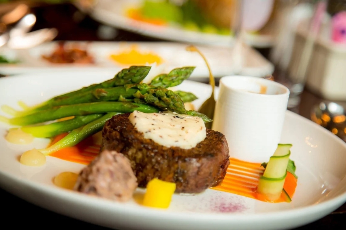 a plate of food with a fork and a glass of wine
