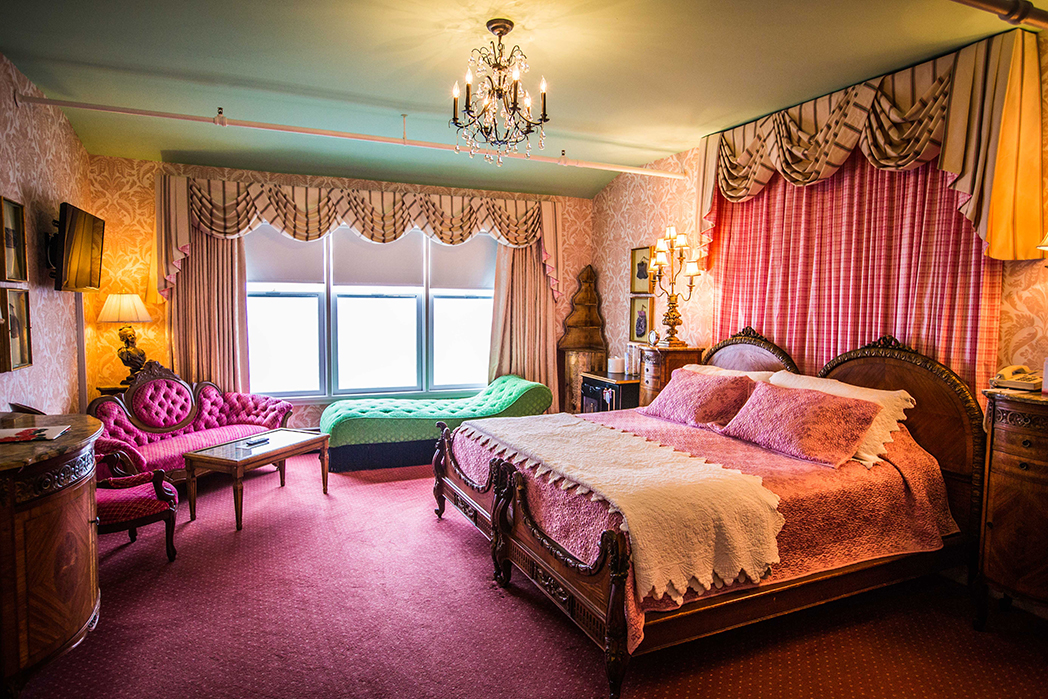 a bedroom with pink and green furniture