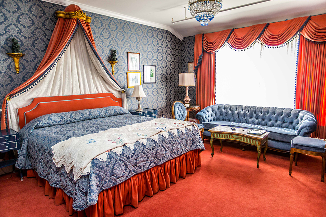 a bedroom with a bed and a couch