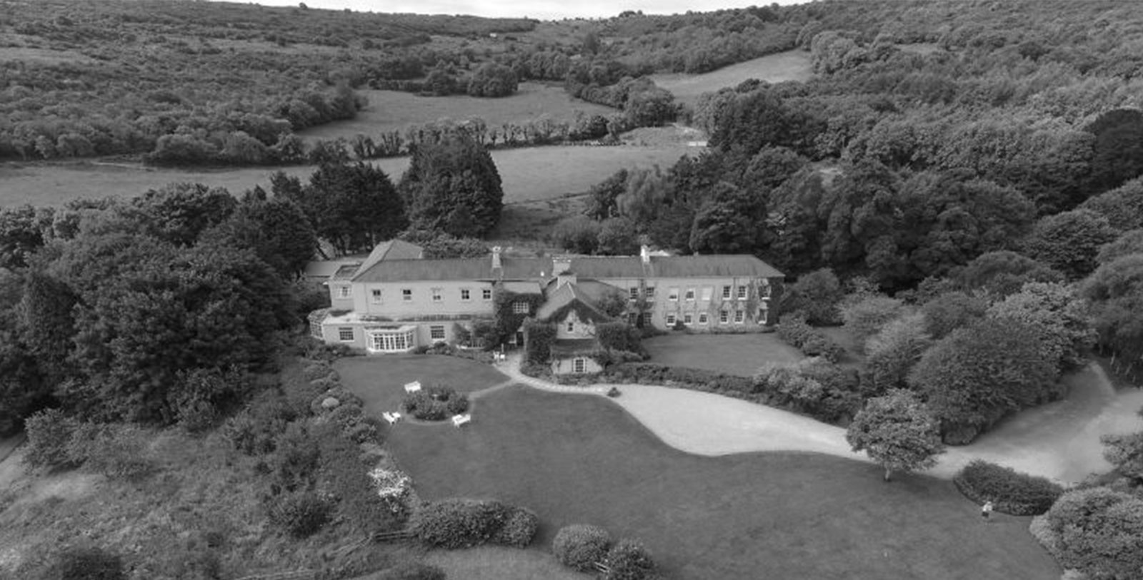 a large house with a large lawn and trees