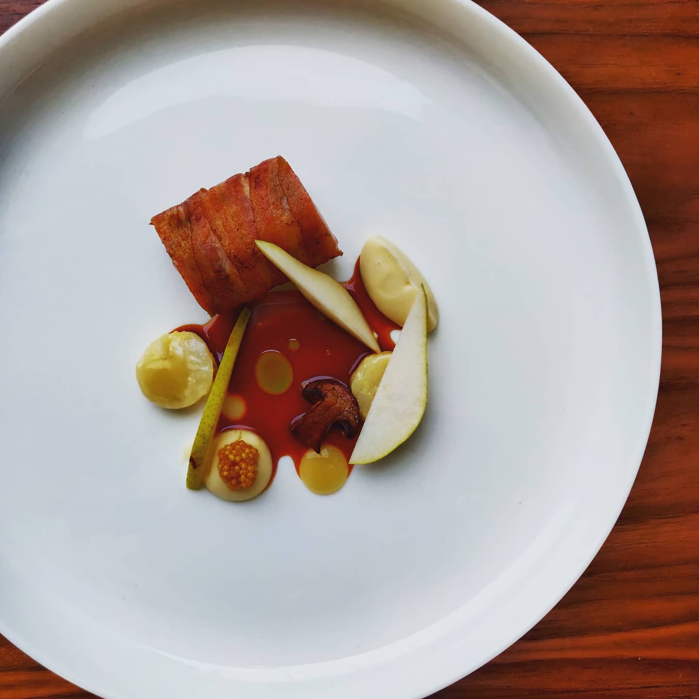 a plate of food on a wood table