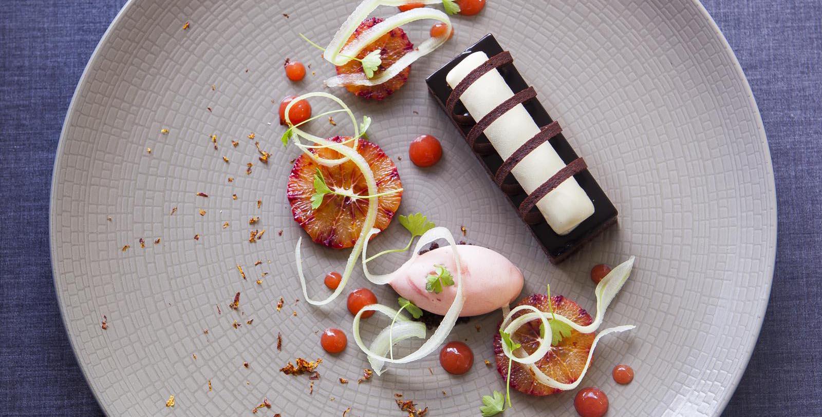 a plate of food with oranges and a chocolate bar