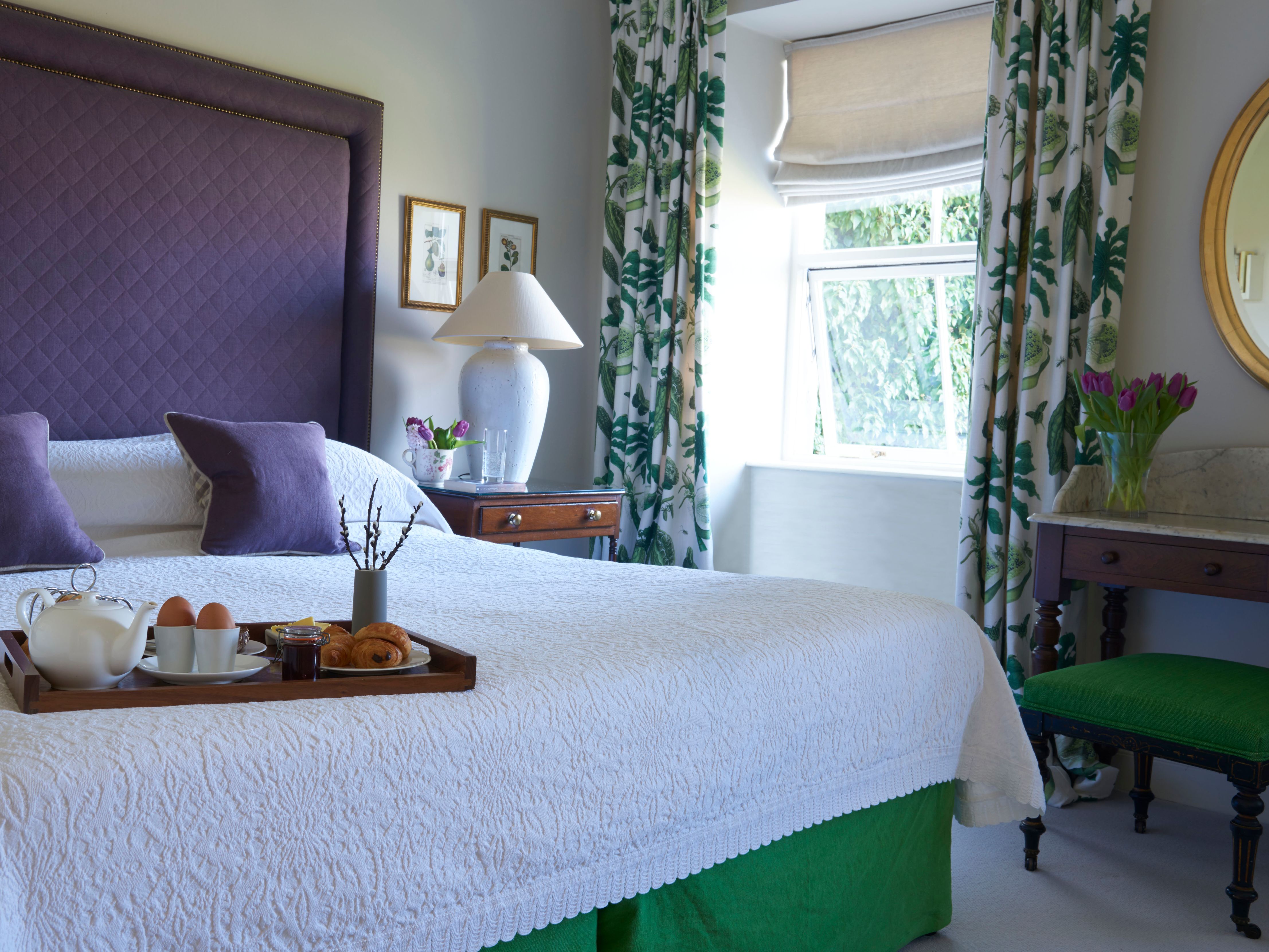 a bed with a tray of food on it