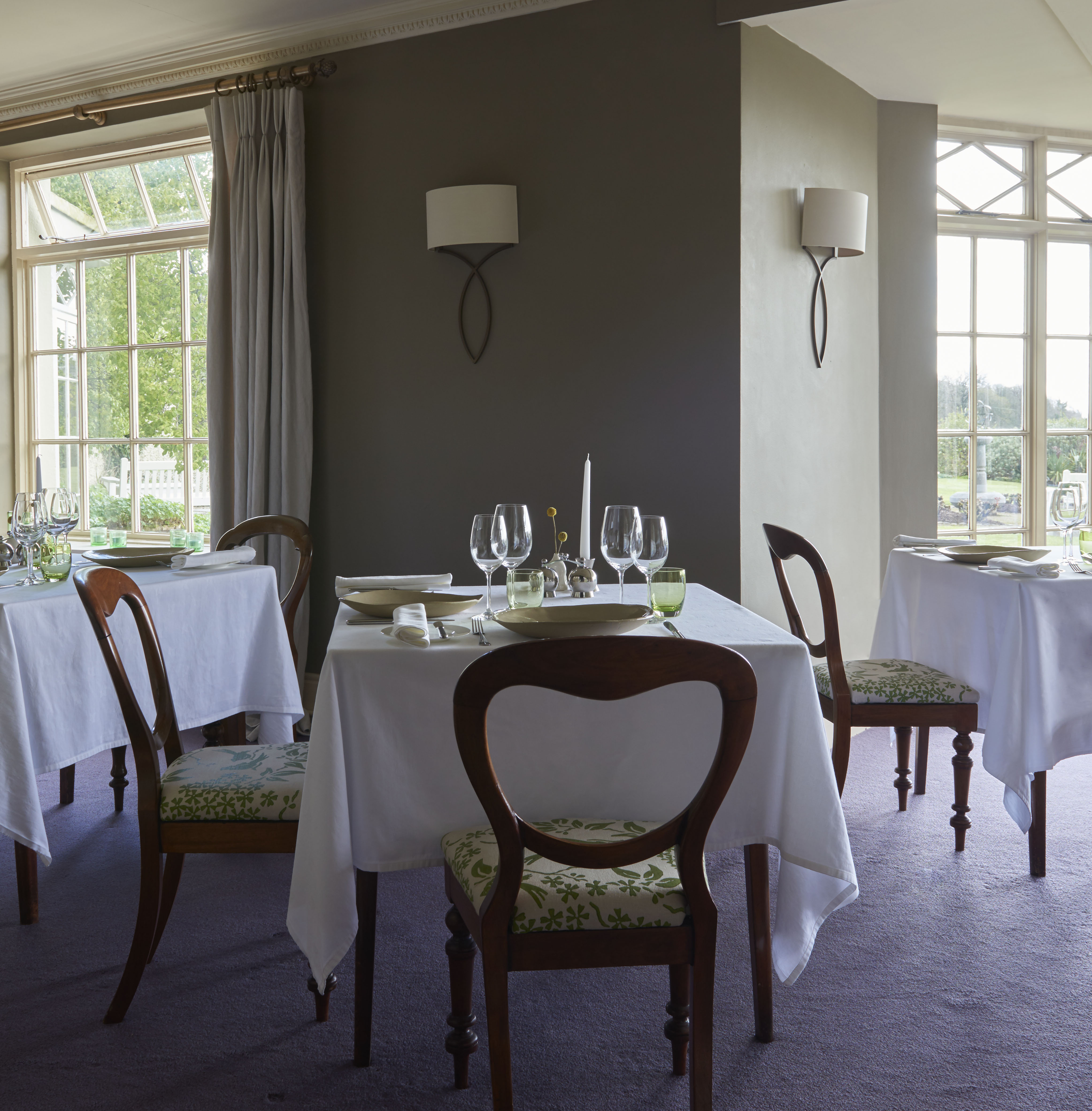 a dining room with a table and chairs