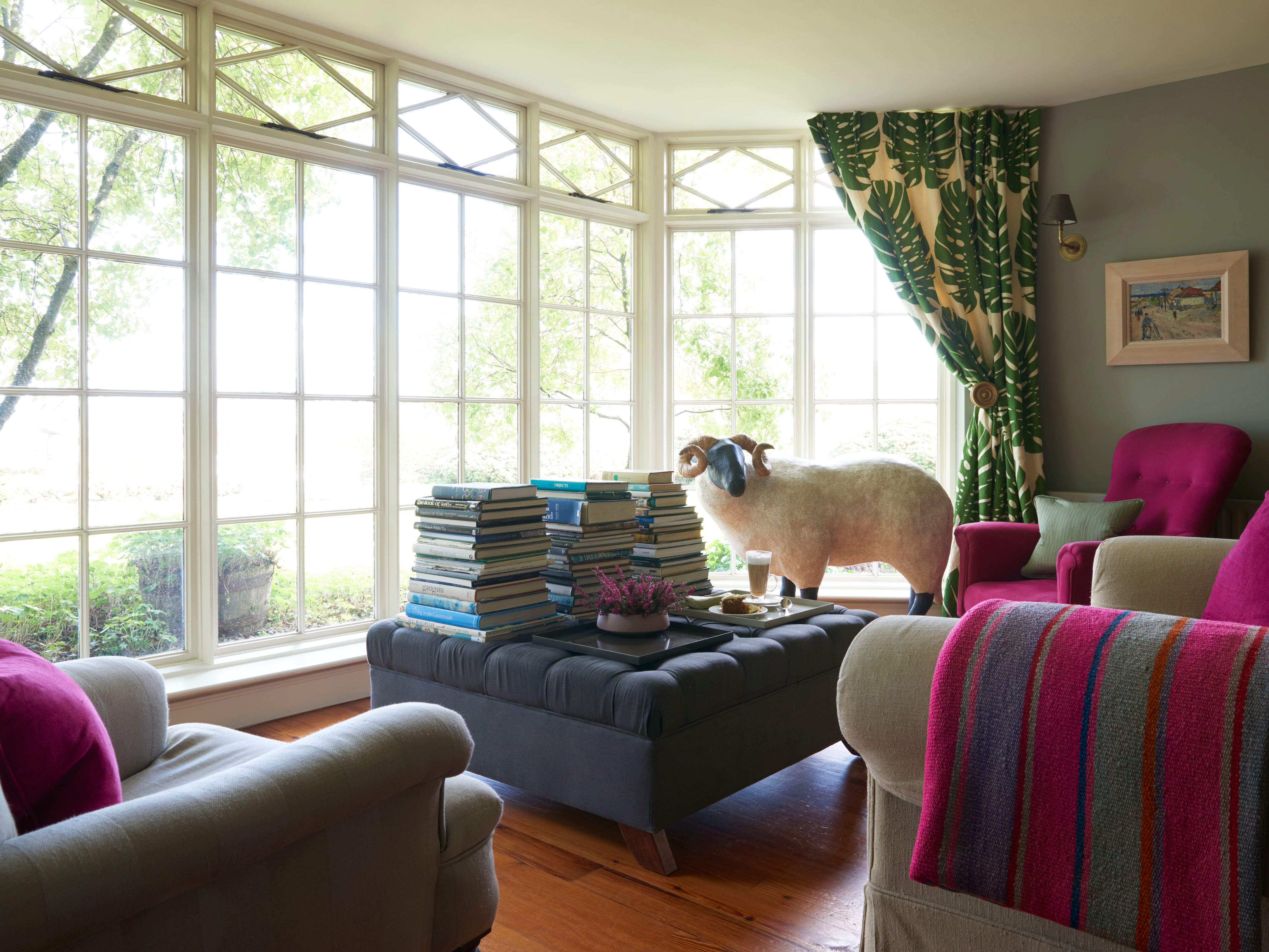 a room with a sheep statue and a coffee table