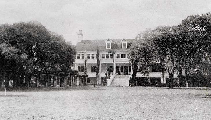 a large building with trees in front