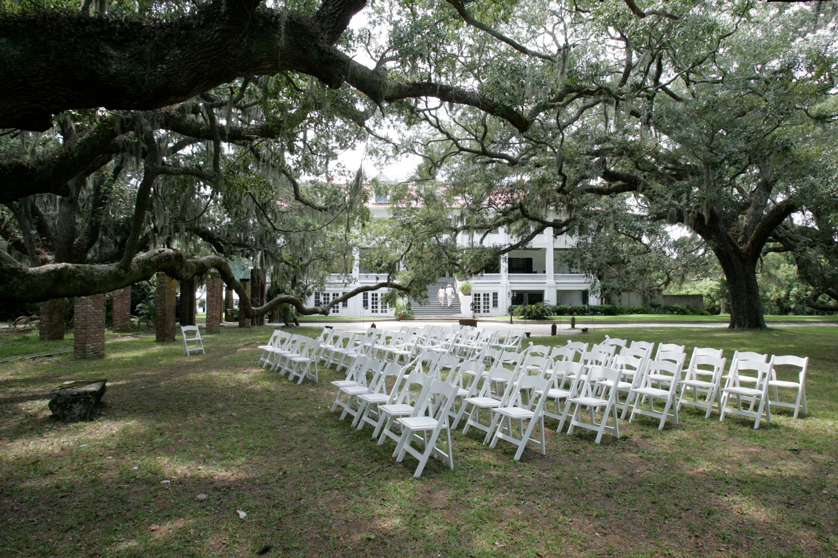 a group of white chairs in a park