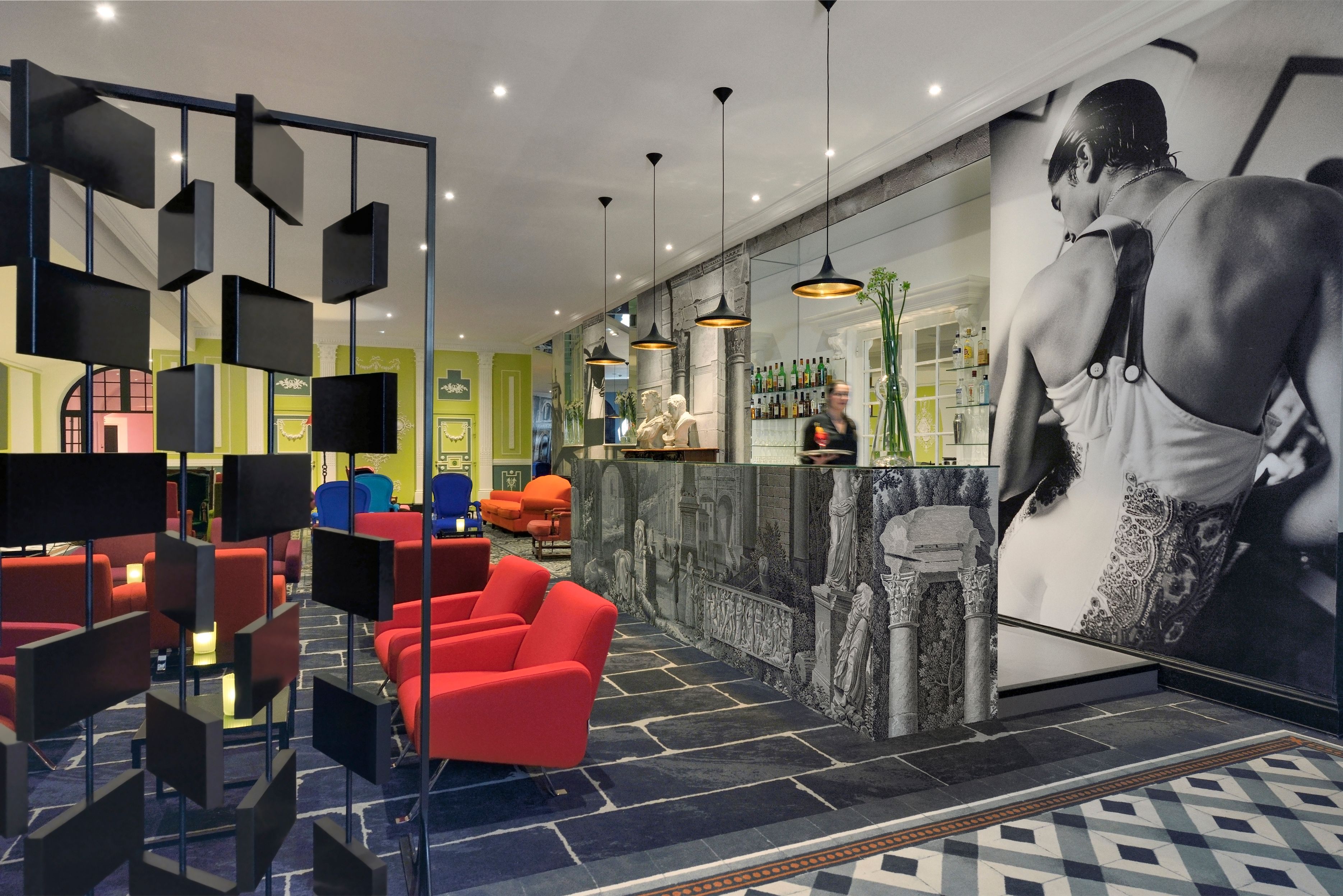 a hotel lobby with a bar counter and chairs
