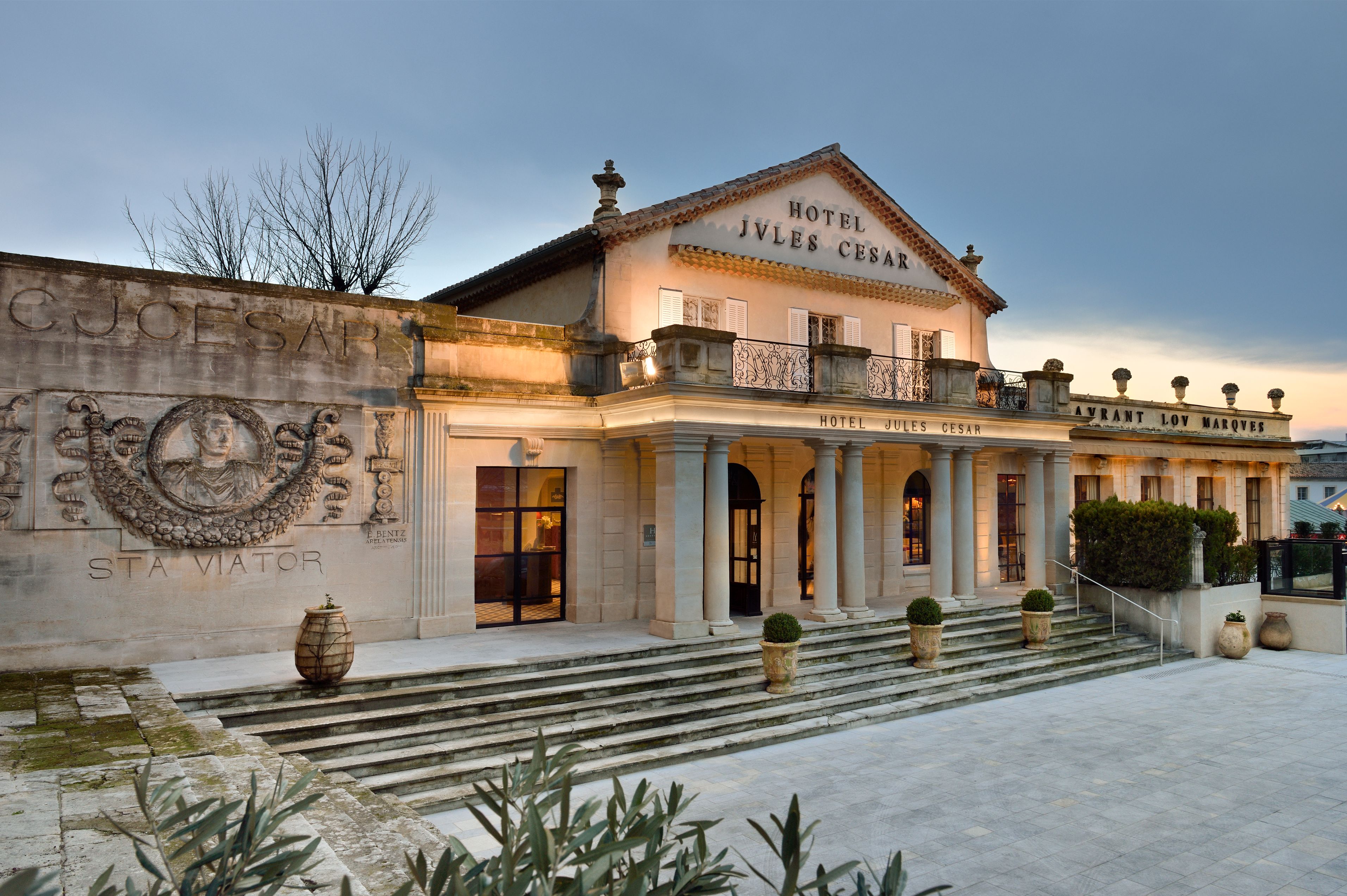 a building with columns and a stone wall